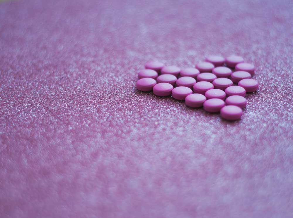 Purple pills on purple background