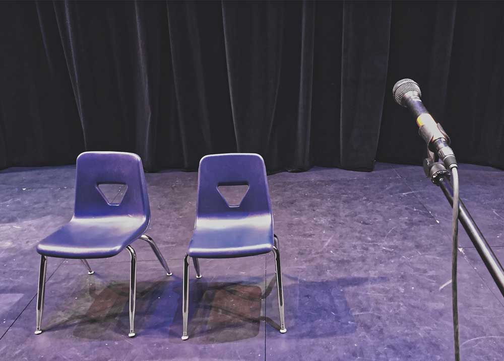 Chairs on stage with microphone